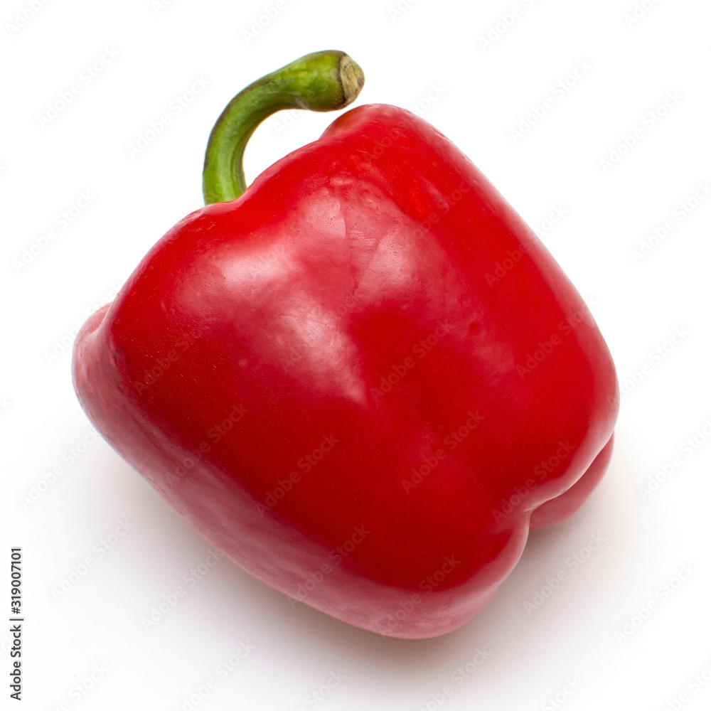 One bright red raw bell pepper with green tail on a white isolated background close-up