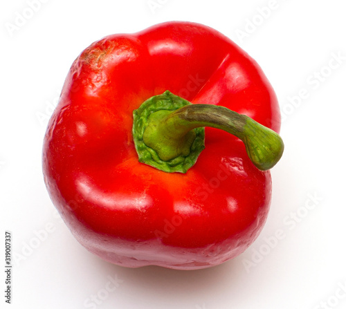 One bright red raw bell pepper with green tail on a white isolated background close-up