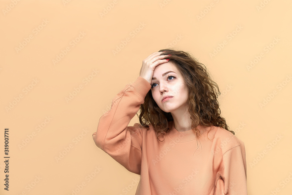 Fototapeta premium Portrait of a young beautiful woman wearing sweatshirt posing isolated over yellow background