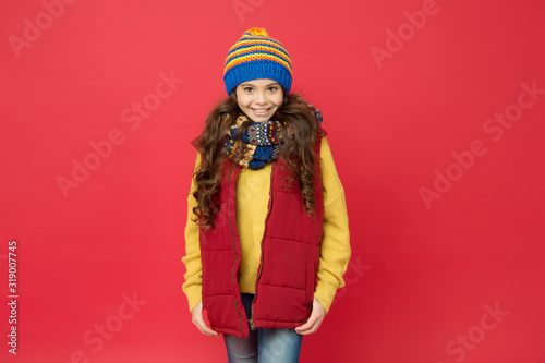 Cheerful smiling hipster child long hair in stylish outfit. Beautiful child. Winter ideas for fun. Fashion shop. Winter fashion for kids. Happy winter holidays activity. Feeling warm and happy