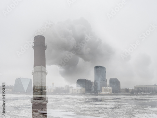 Double exposure of a pipe with smoke on the background of a winter city. © sablinstanislav