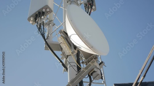 satellite dishes and repeaters against the blue sky. Concept of data transmission system development photo