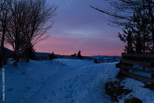 Sunset in the Ukrainian Carpathians. Winter in the village. Nature.