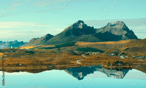 the town Borg is reflected in the mirror of the lake. Autumn nature landscape of Norway on Lofoten islands.