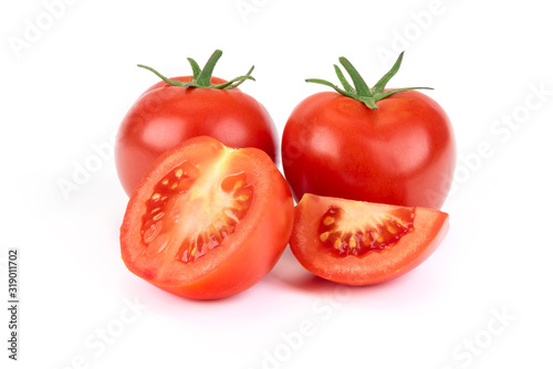 Group of whole and sliced tomatoes isolated on a white background in close-up