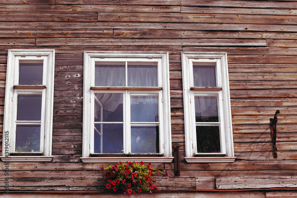 three white wooden window frames and flower box three white wooden window frames and flower box