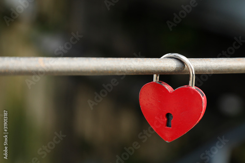 Red heart lock as a symbol for love like valentines day or wedding, space for text, nobody and horizontal