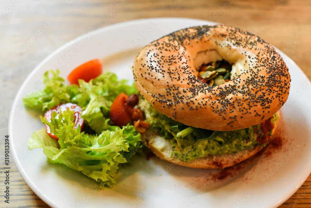 Vegan bagel with hummus and vegetables Vegan bagel with hummus and vegetables