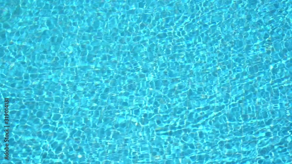 Abstract blue video background of sunny rippling fresh water in outdoors swimming pool of tropical hotel resort. Abstract blue video background of sunny rippling fresh water in outdoors swimming pool of tropical hotel resort.