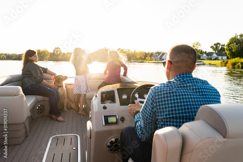 Family on a pontoon boat in summer  photo