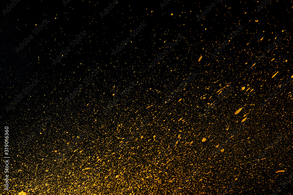 Golden dots of paint on a black background. Abstract background. Web banner.