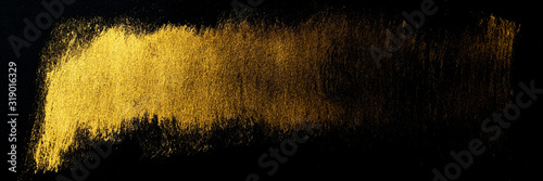 Golden Traces of a Stroke with an Acrylic Paint .