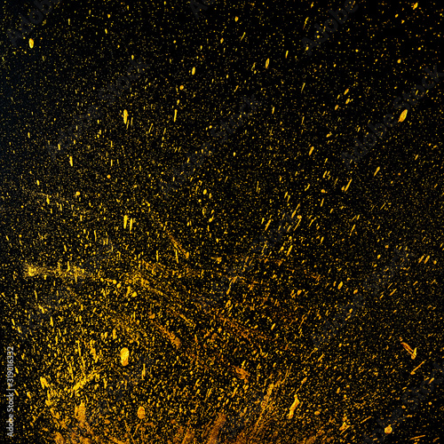 Golden dots of paint on a black background. Abstract background. Web banner. photo