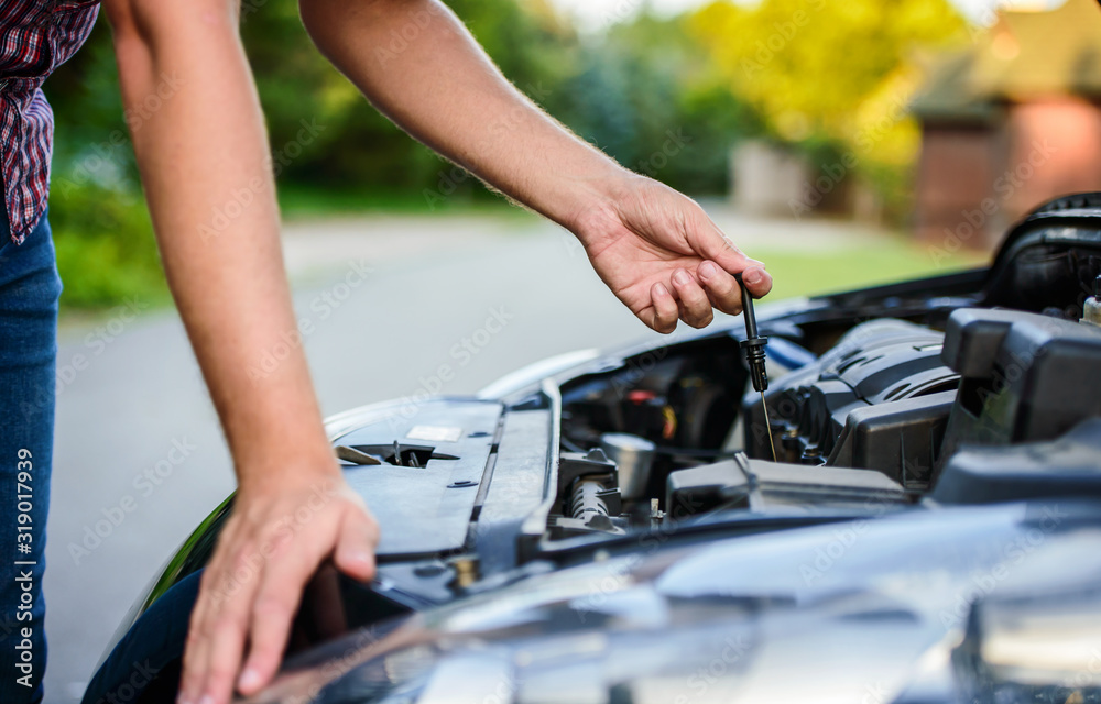 Always checks the oil level in the engine, close up photo. Cars and transportation concept