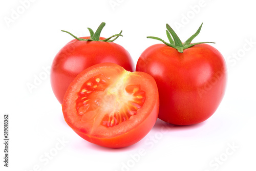 Group of whole and sliced tomatoes isolated on a white background in close-up