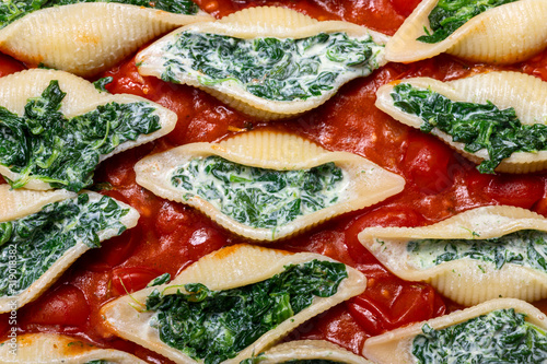 italian conchiglino pasta filled with spinach photo