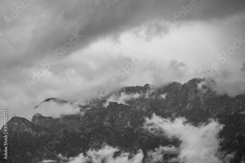 Black and white photography of cloudy stormy sky over mountains. Rainy weather. Turkey. Horizontal color photography.