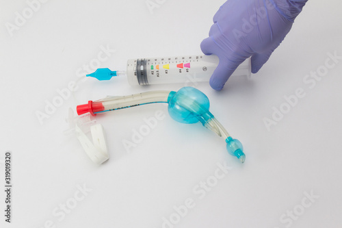 Laryngeal tube kit filling with air by a doctor isolated at the white background, LTS-D