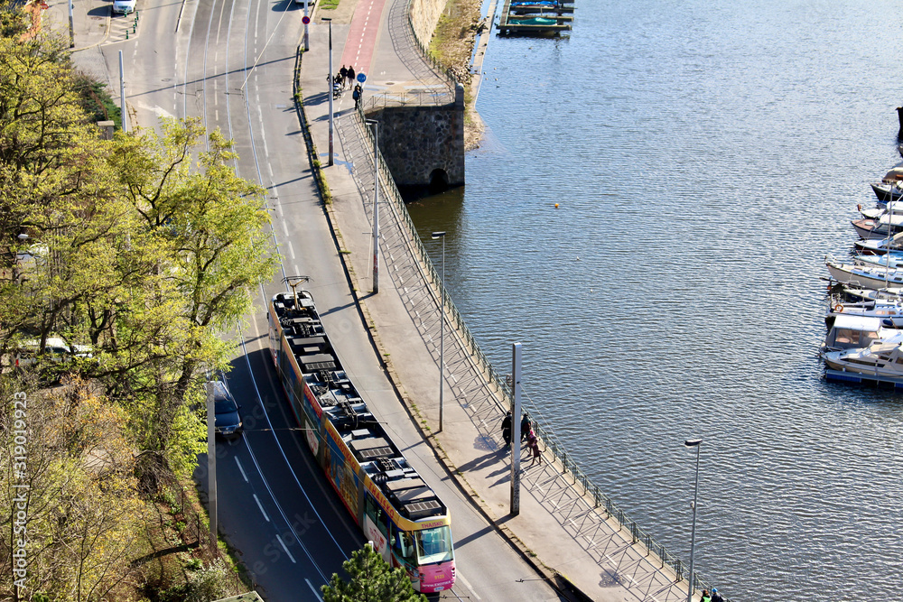 Overhead view of Prague tram on road near river