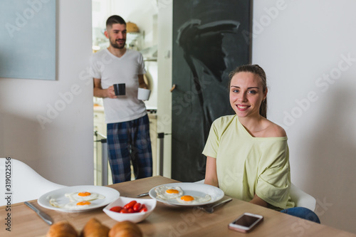 happy romantic couple having breakfast at home