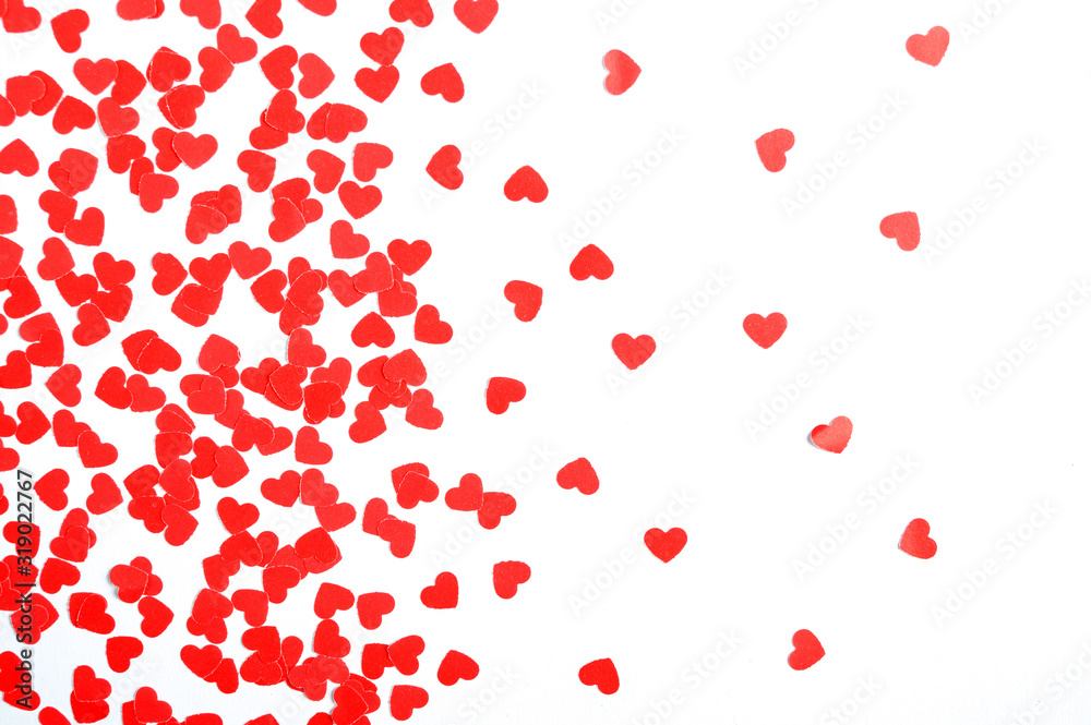 Valentines Day background. Red hearts on a white background. Flat lay, top view, copy space.