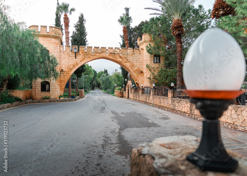 The road leading under a beautiful brick arch with columns. Cyprus local attraction. A popular tourist destination.