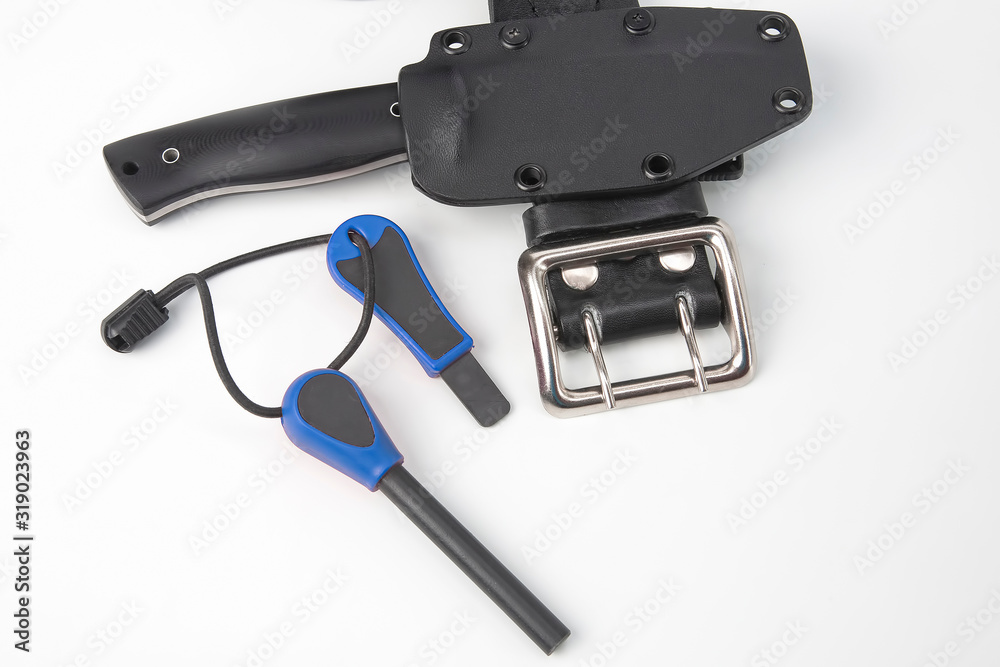knife for tourism and hunting with a plastic case on a black leather belt on a white background. ignition steel for striking fire knife for tourism and hunting with a plastic case on a black leather belt on a white background. ignition steel for striking fire