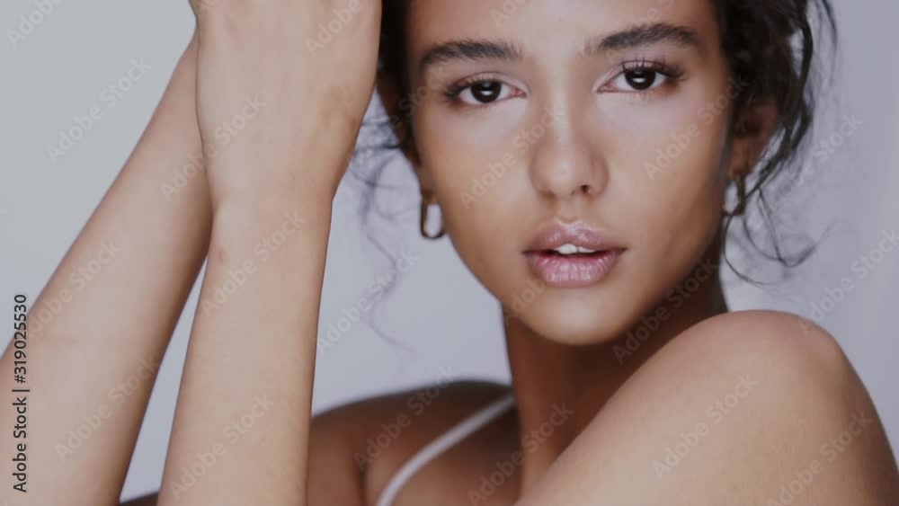 beauty portrait of woman posing and touching her face with perfect healthy skin and attractive smile beauty portrait of woman posing and touching her face with perfect healthy skin and attractive smile