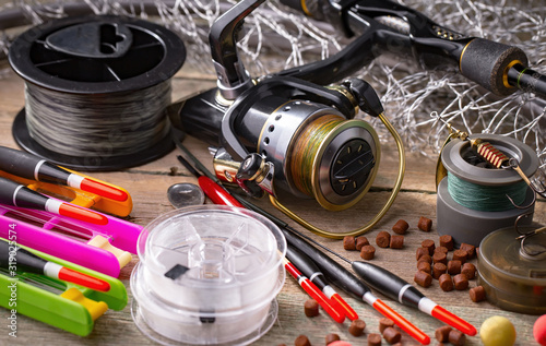 fishing tackle on a wooden table. toned image