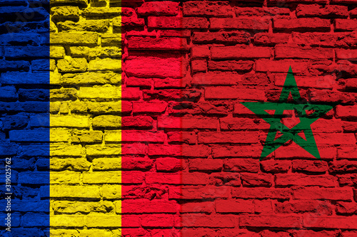 Flag of Romania and Morocco on brick wall