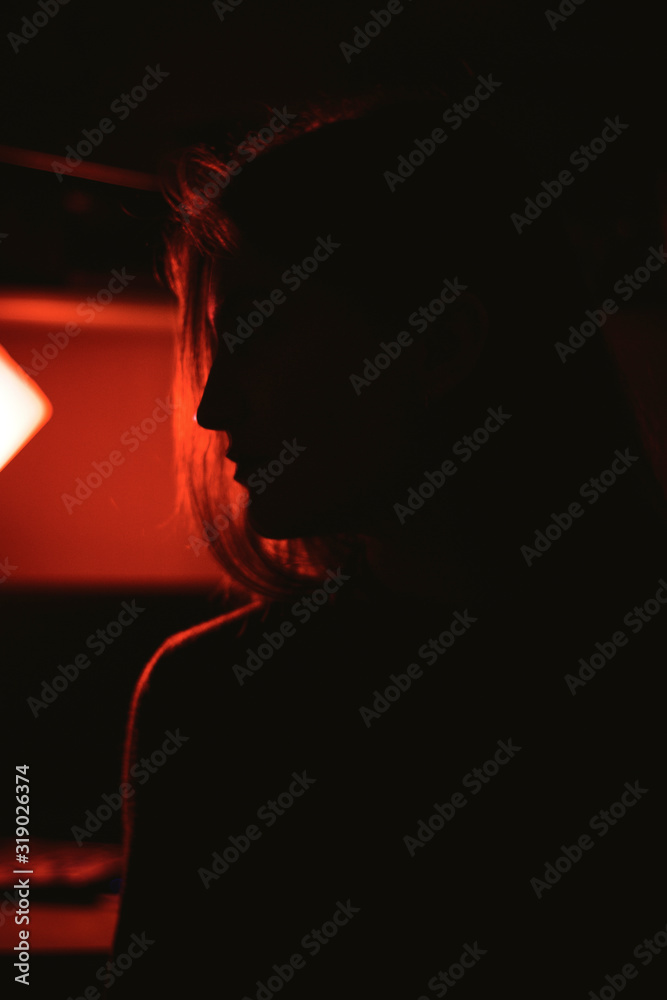 silhouette of woman in dark red background