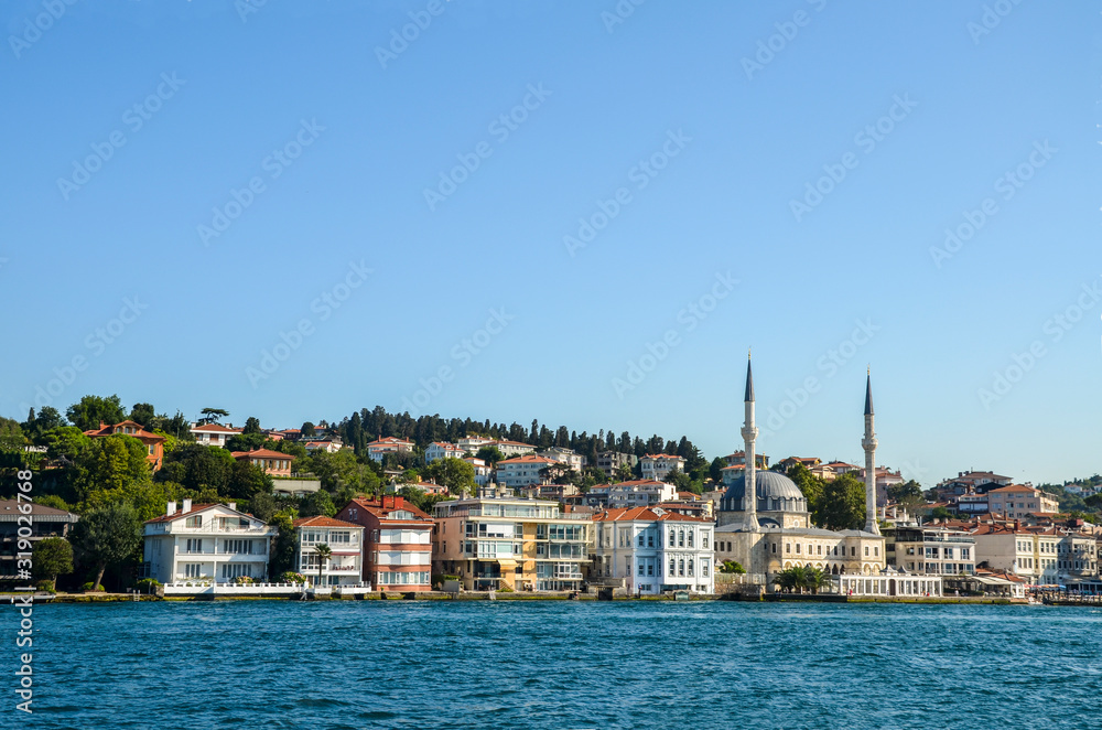 View of the Beylerbey Mosque, modern buildings and the embankment, from the Bosphorus, Istanbul, Turkey