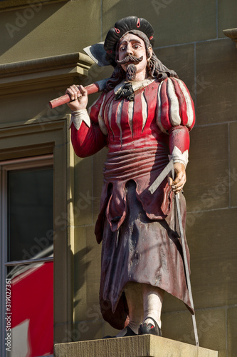 The statue of the butcher decorates frontage of a building in the old town of Bern, Switzerland