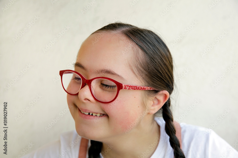Portrait of little girl smiling on background of the wall Portrait of little girl smiling on background of the wall