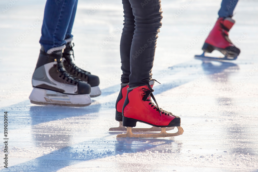 different people are actively skating on an ice rink. hobbies and leisure. winter sports different people are actively skating on an ice rink. hobbies and leisure. winter sports