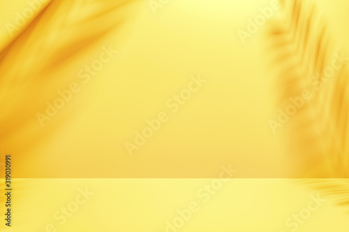 Two palm fronds casting shadows on a yellow wall