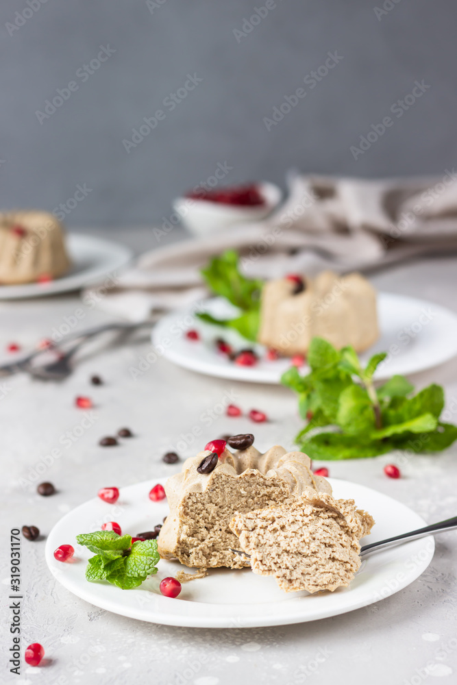 Vegan mini cheesecakes with coffee and banana garnished with coffee beans, pomegranate and mint. No crust coffee cheesecake. Vegan mini cheesecakes with coffee and banana garnished with coffee beans, pomegranate and mint. No crust coffee cheesecake.
