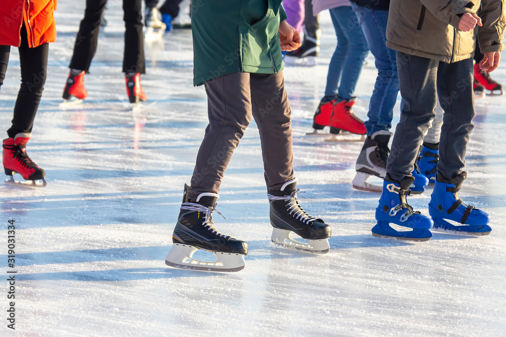 different people are actively skating on an ice rink. hobbies and leisure. winter sports different people are actively skating on an ice rink. hobbies and leisure. winter sports