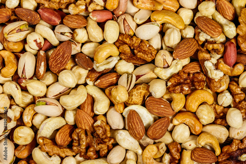 Background of mixed nuts (walnuts, pistachio, almond, peanut, cashew, hazelnut). Healthy eating concept Background of mixed nuts (walnuts, pistachio, almond, peanut, cashew, hazelnut). Healthy eating concept