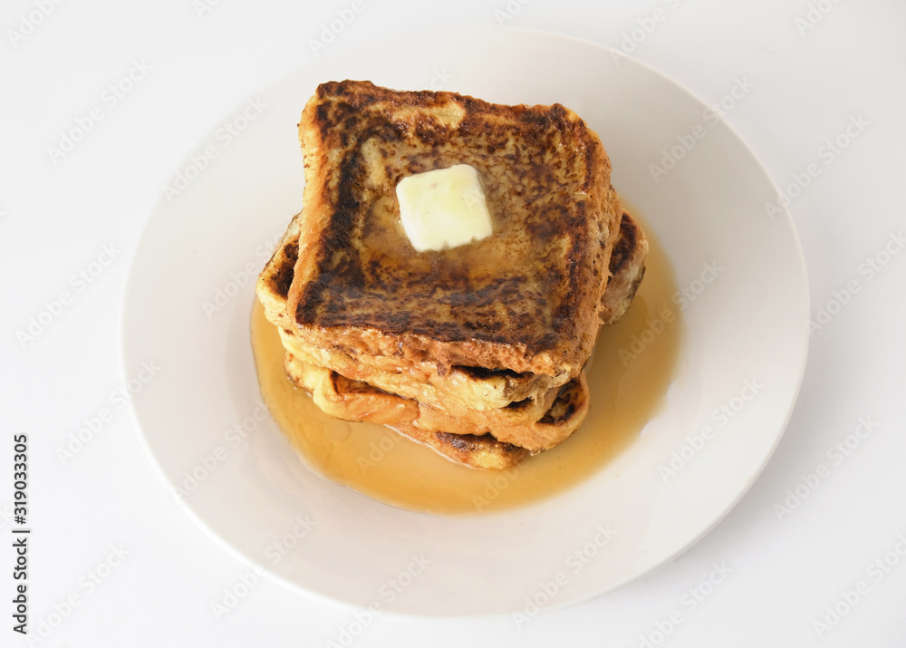 Stack of french toast bread with maple syrup and butter for breakfast food on white plate background. Stack of french toast bread with maple syrup and butter for breakfast food on white plate background.