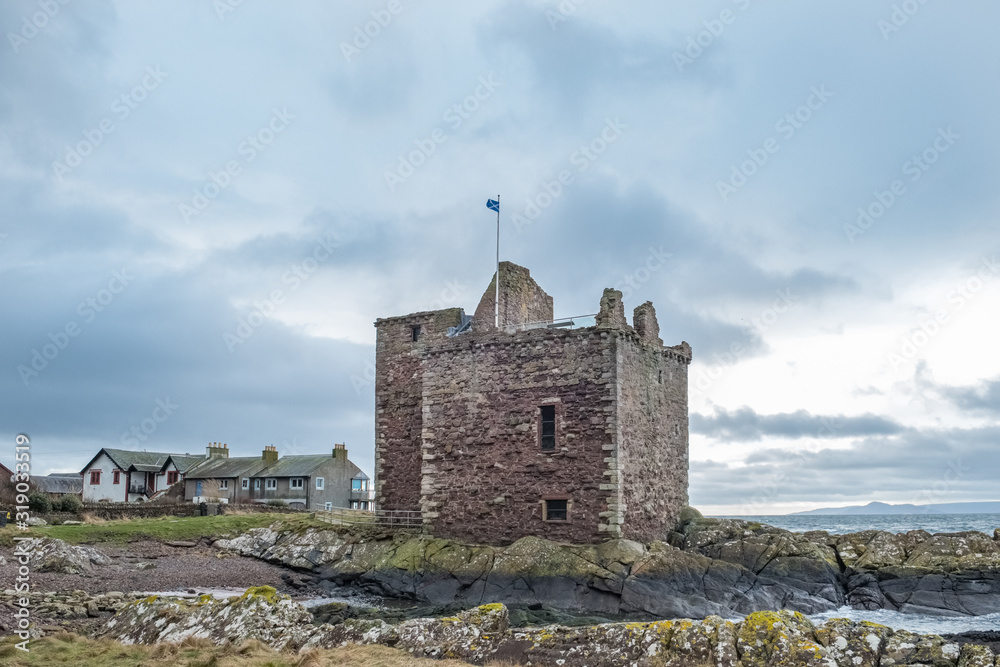 Saltire Flag of Scotland Flying Proudly from the Old Castle Ruins that are Portencross in Seamill Scotland