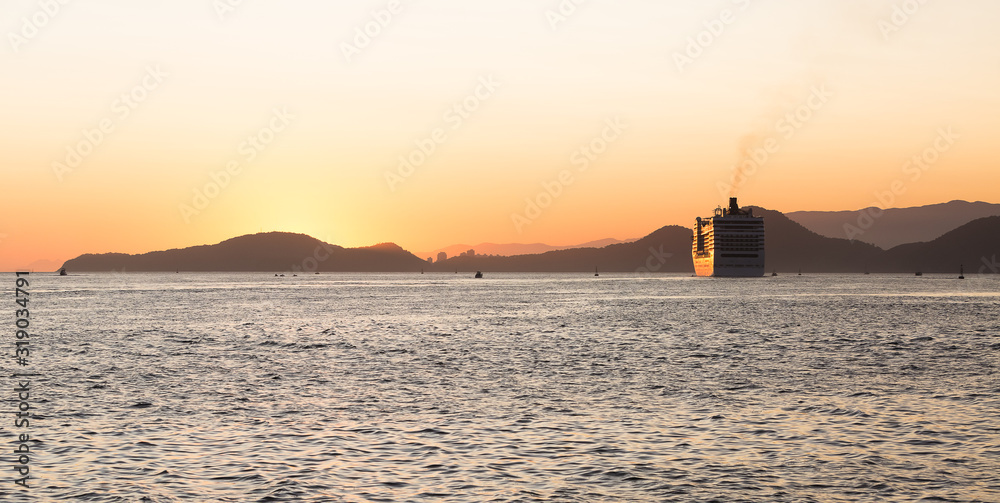A cruise ship leaving the port of Santos, Brazil, during a beautiful summer sunset