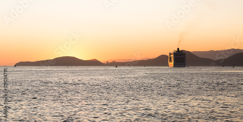 A cruise ship leaving the port of Santos, Brazil, during a beautiful summer sunset