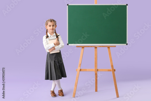 Little schoolgirl near blac...