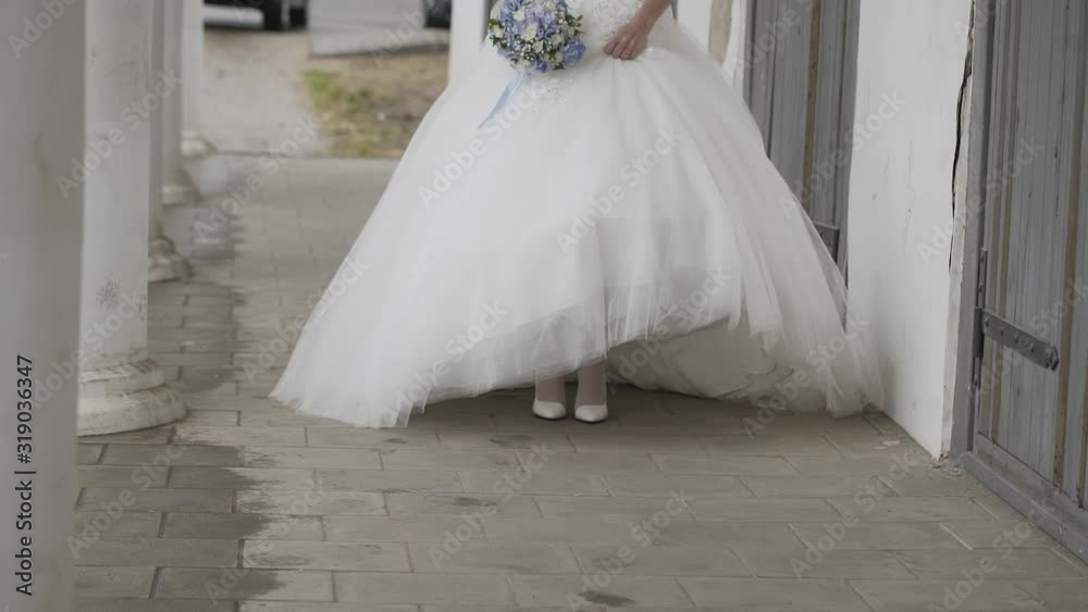The bride walks and spins in a light wedding dress. The bride walks and spins in a light wedding dress.