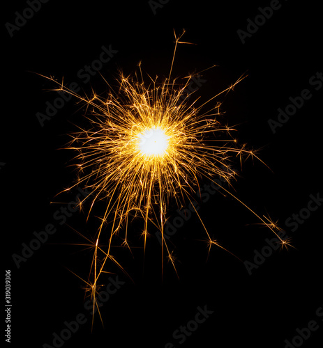 New Year or Christmas bengal fire  sparkler fireworks candle isolated on a black background. Party dark backdrop.