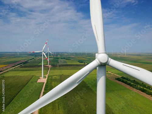 Aerial View of Giant Wind Turbine Rotating in Strong Winds - Green Energy