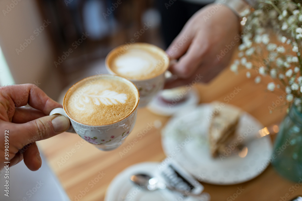 Hands holding coffee cups