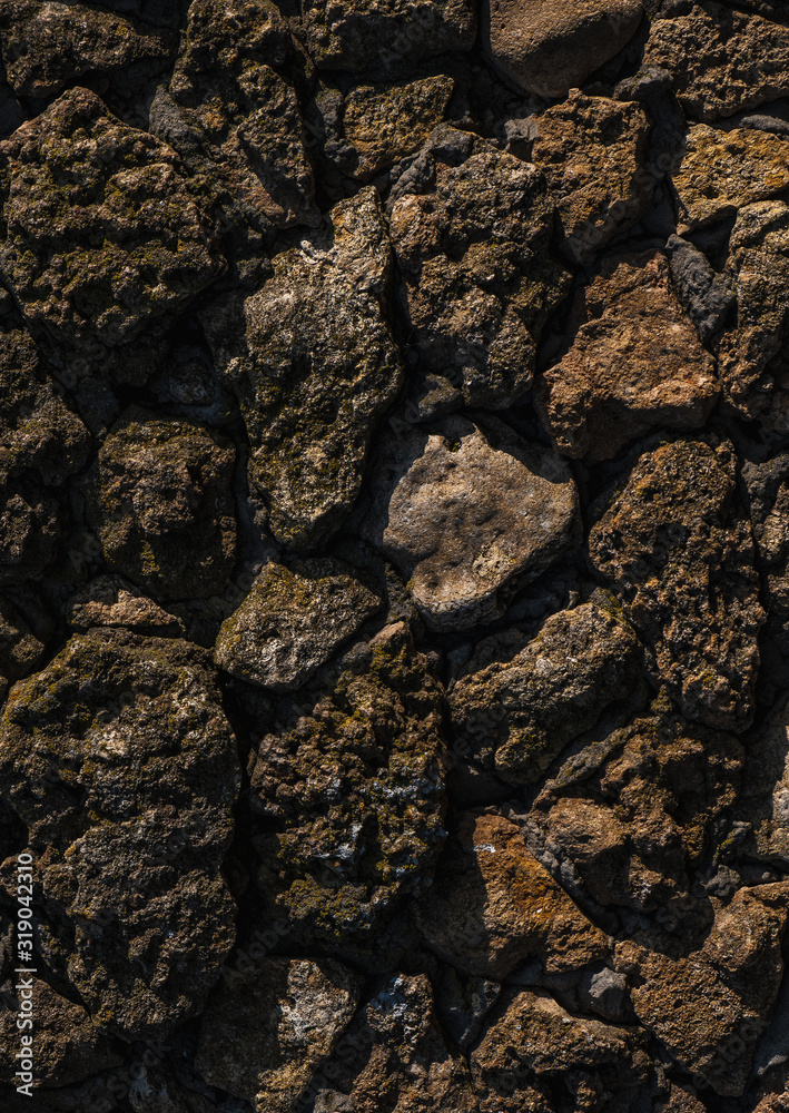 Stone texture. old rough stones tightly adjacent to each other. Dark stone floor or wall. Background from old stones. Stone texture. old rough stones tightly adjacent to each other. Dark stone floor or wall. Background from old stones.