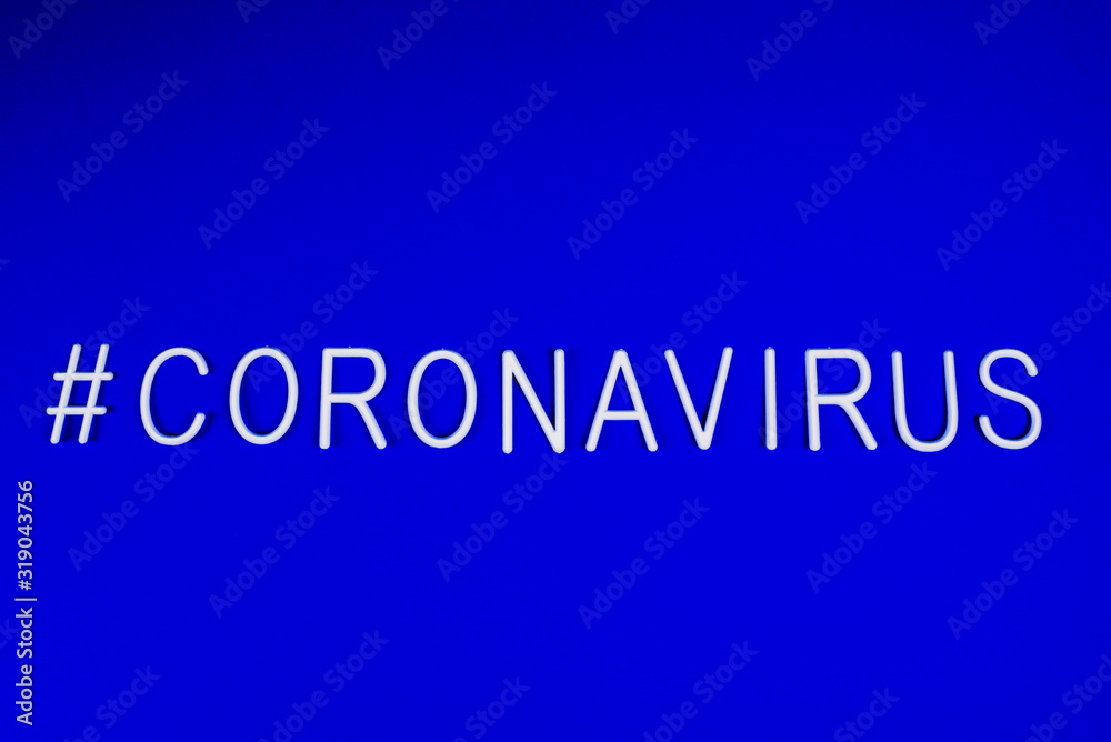 the word coronavirus laid with white letters on classic blue background. News on social networks. Hashtag. Flat lay, copyspace